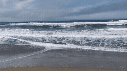 Ocean waves rolling onto a sandy beach