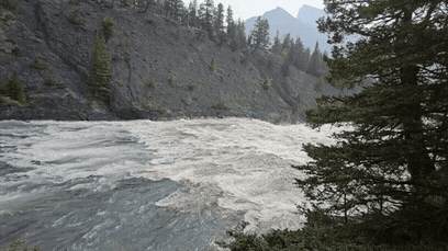 River rapids A fast-moving river rushing past a rocky cliffside